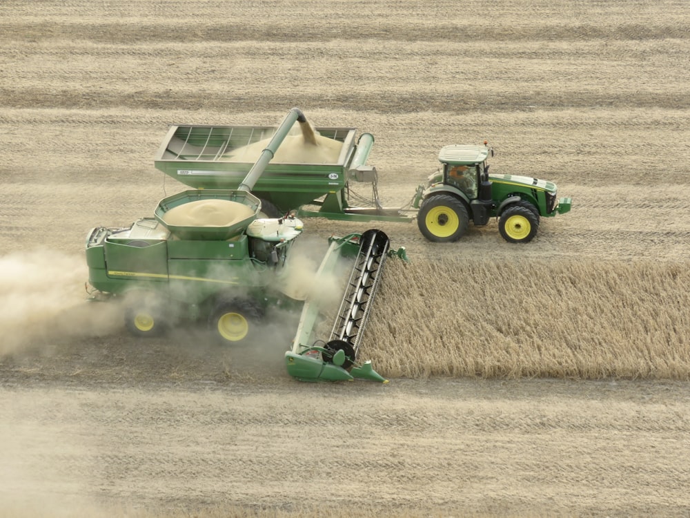 green and black tractor on brown field during daytime