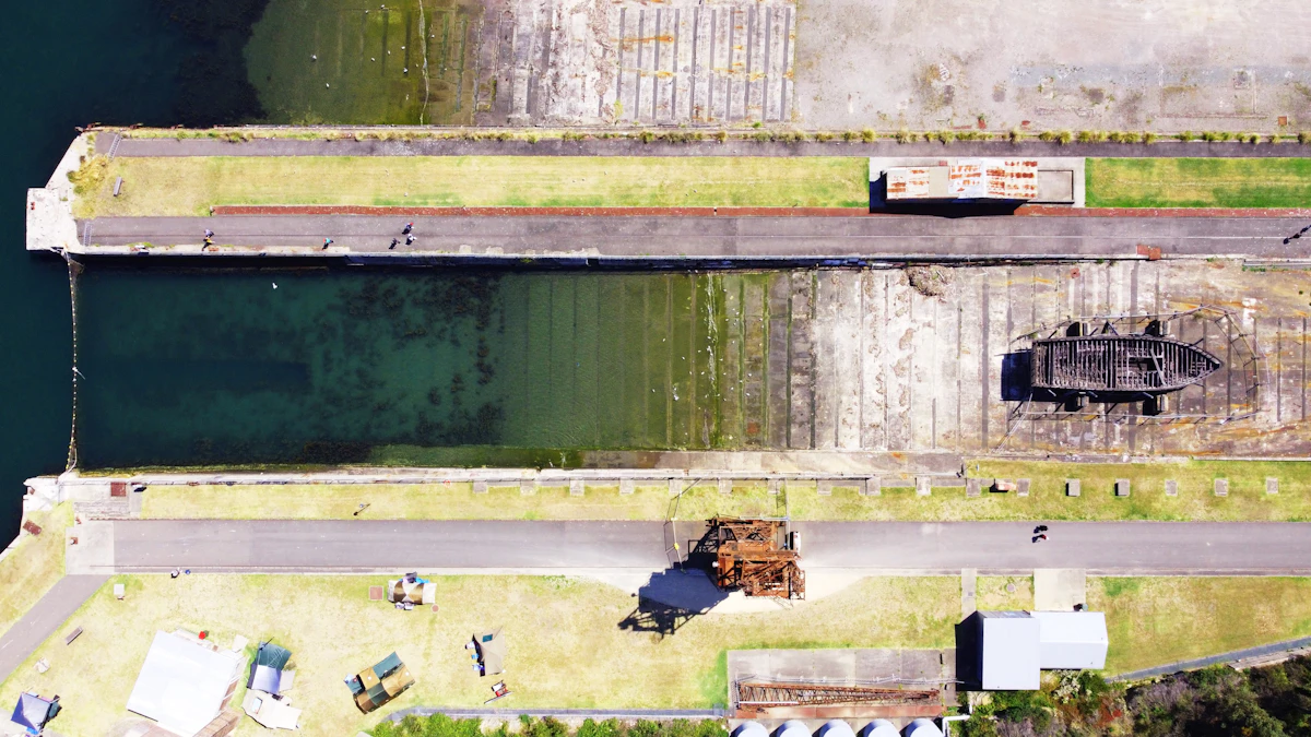 Aerial view of Cockatoo Island dry dock, industrial cranes and campground tents