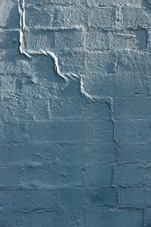 blue concrete wall with white paint