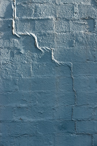 blue concrete wall with white paint