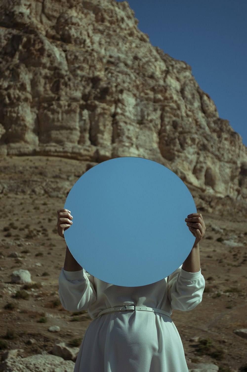 person holding blue round board