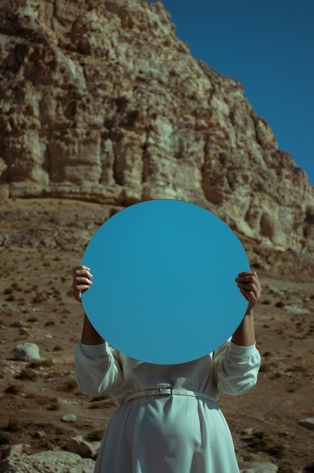  person holding blue round board mirror