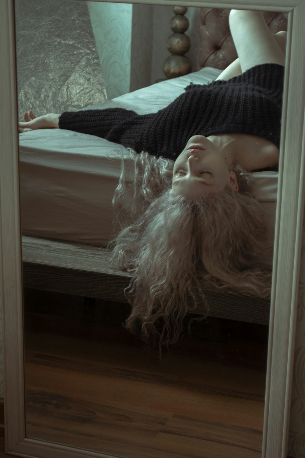 woman in black and white stripe shirt lying on bed