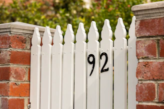 white wooden fence with number 8