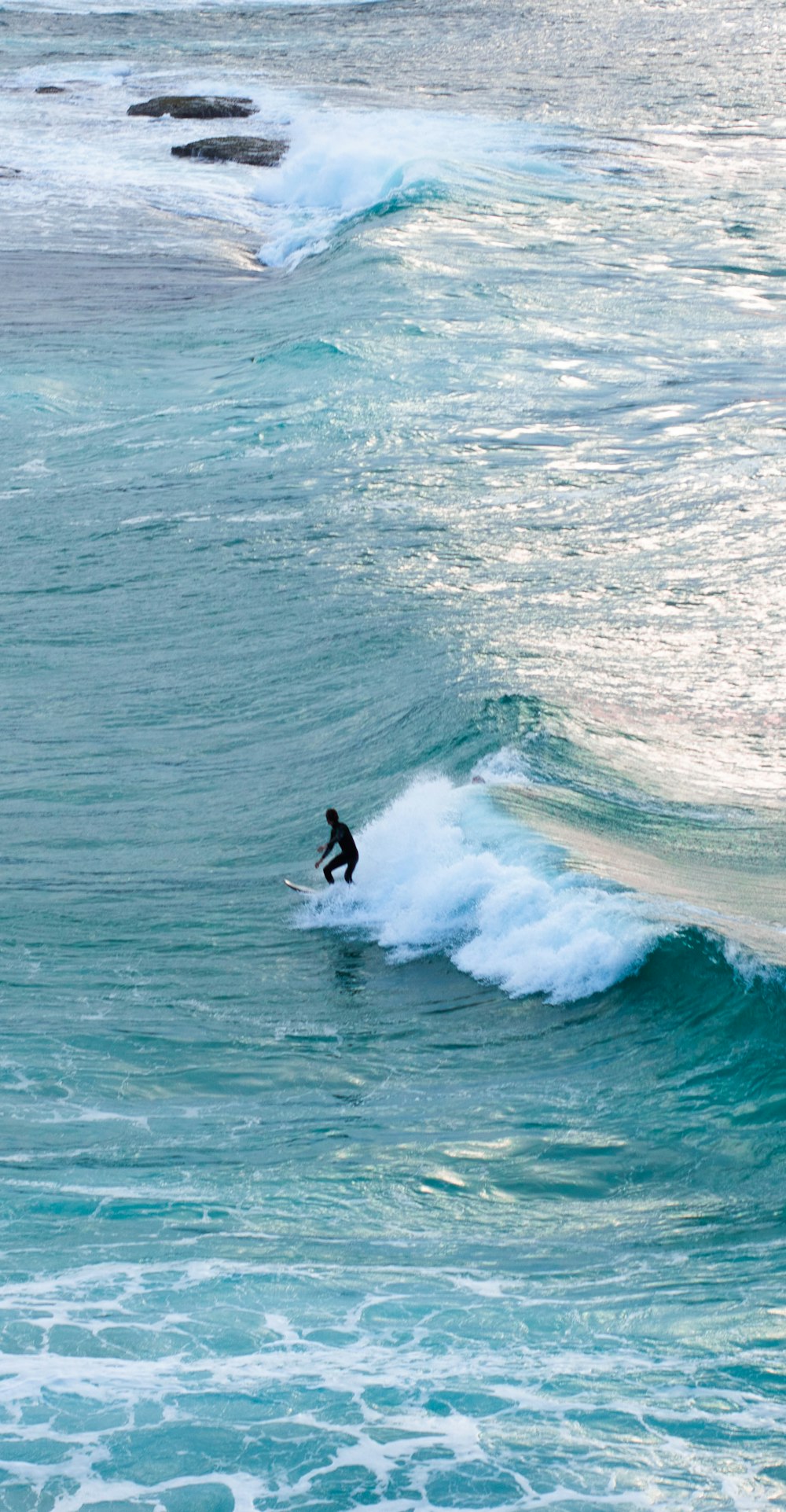 man surfing on sea waves during daytime