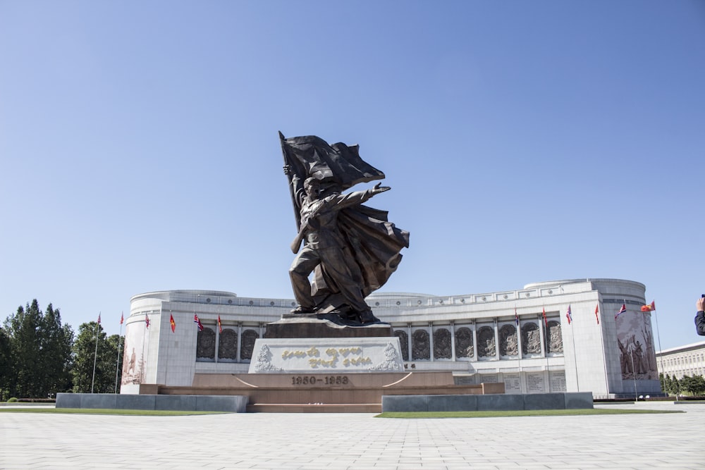 Statua nera sul campo di erba verde durante il giorno