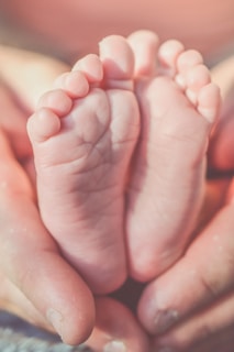 persons hand with pink nail polish