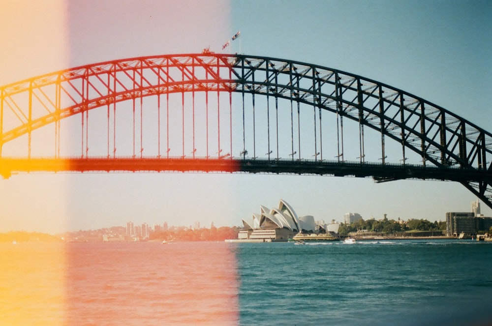 black metal bridge over body of water during daytime