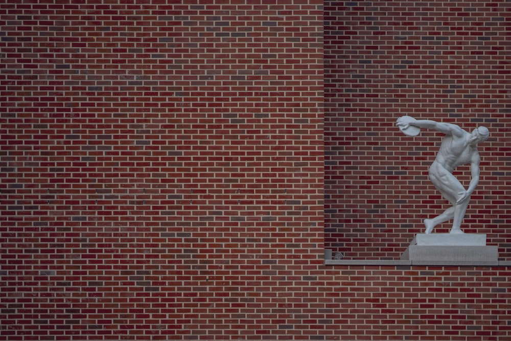 red brick wall with white heart sticker