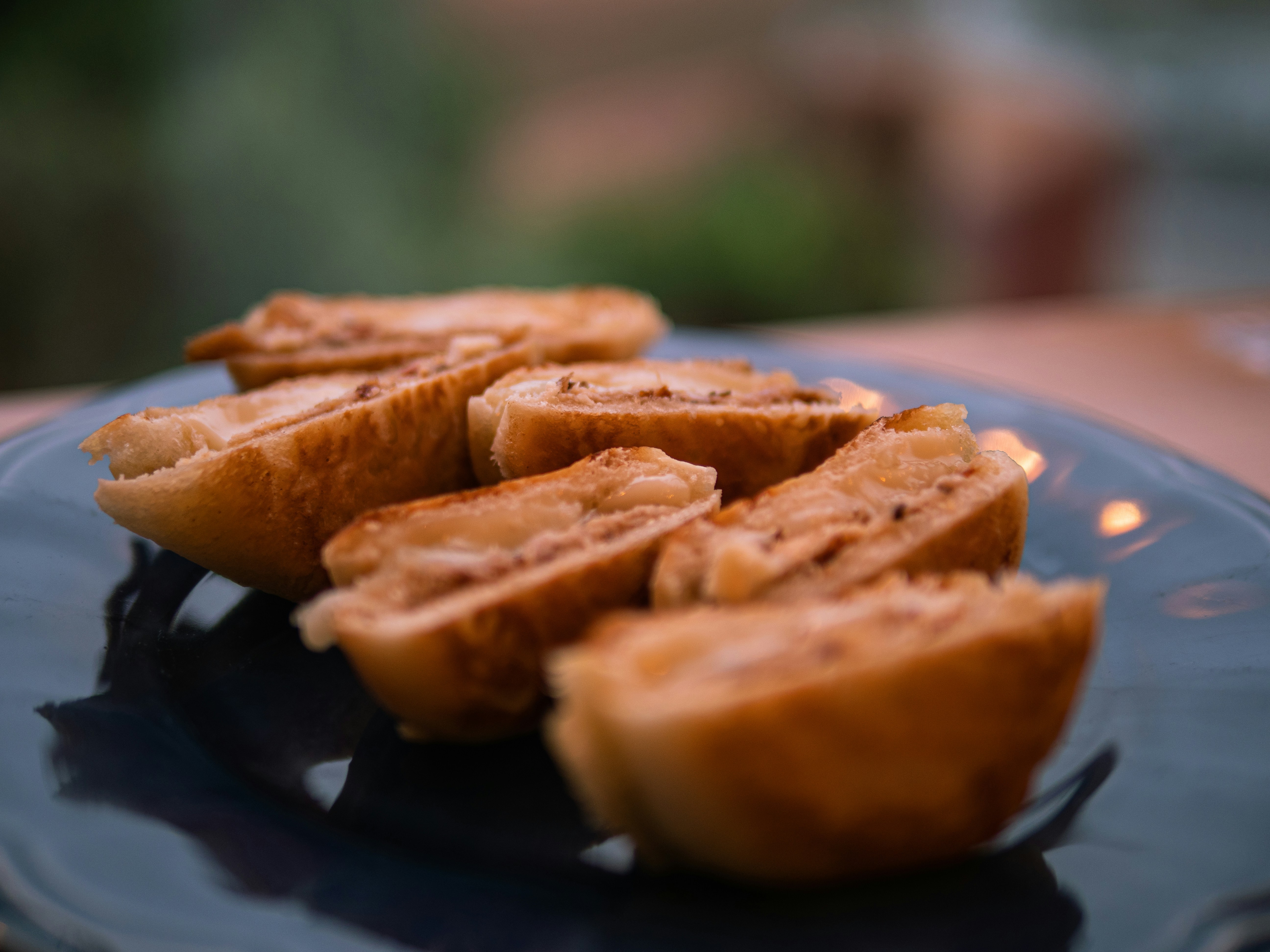 Elegant crepes folded with Oreo crumble and dark chocolate sauce on moody dark plate, soft atmospheric lighting