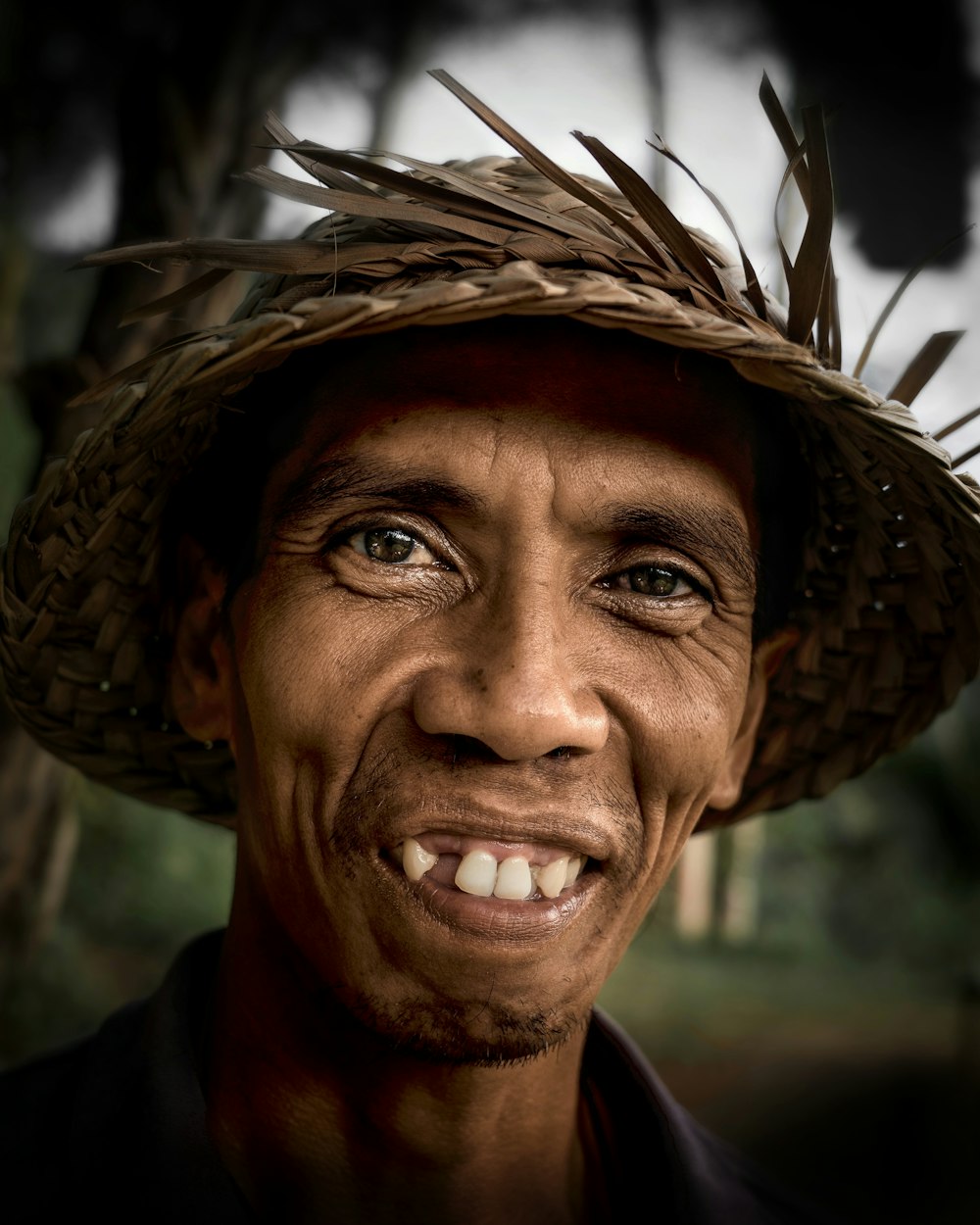 man in brown woven hat