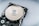 A close-up view of an opened hard disk drive, showcasing the shiny, reflective surface of the platter and the read/write head assembly. The metallic components are contrasted against a neutral background.
