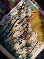 A textured painting of flowers on a piece of paper. The artwork features white petals with yellow centers, set against a vibrant background containing swirls of blue, green, and a prominent section of yellow, mimicking the sun. The painting is done using thick, textured brushstrokes that create a 3D effect.