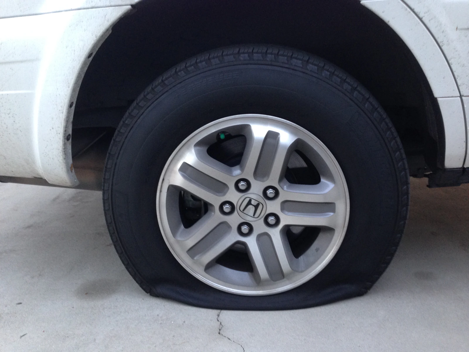 Vehicle with a visibly flat tire stranded