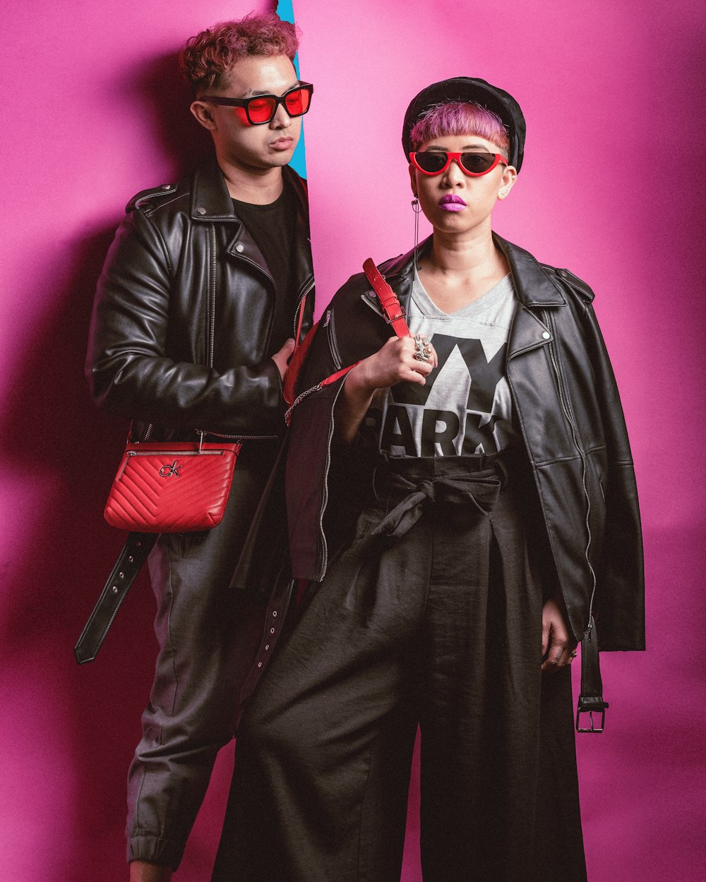 man in black leather jacket standing beside woman in black leather jacket