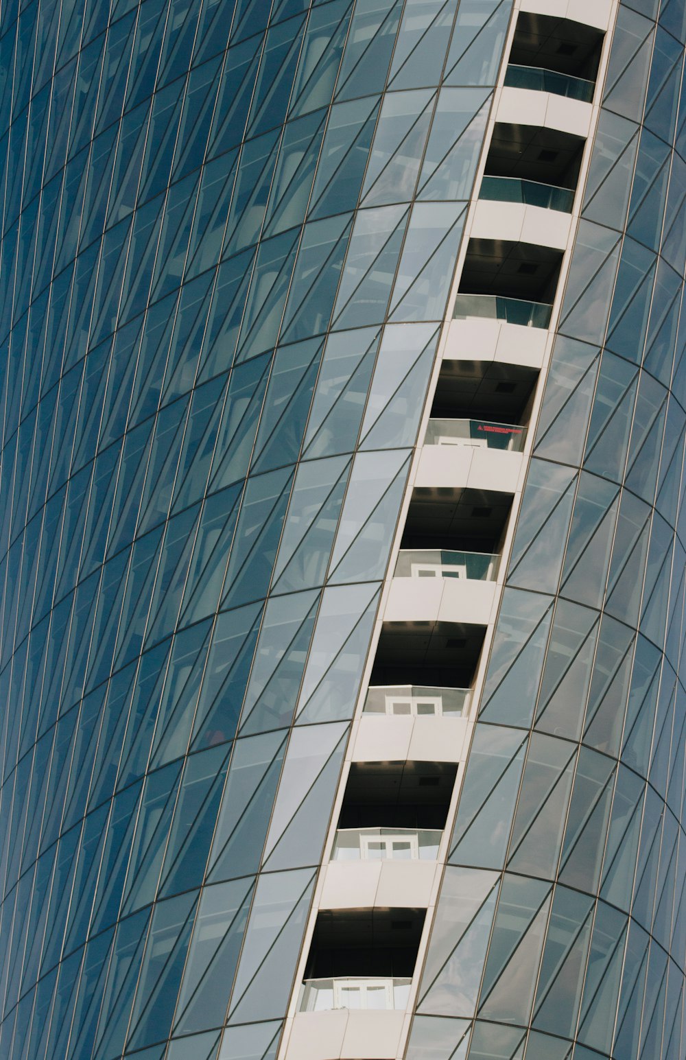 blue glass walled high rise building