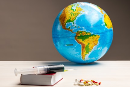 blue and green globe on white table