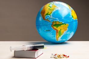 blue and green globe on white table