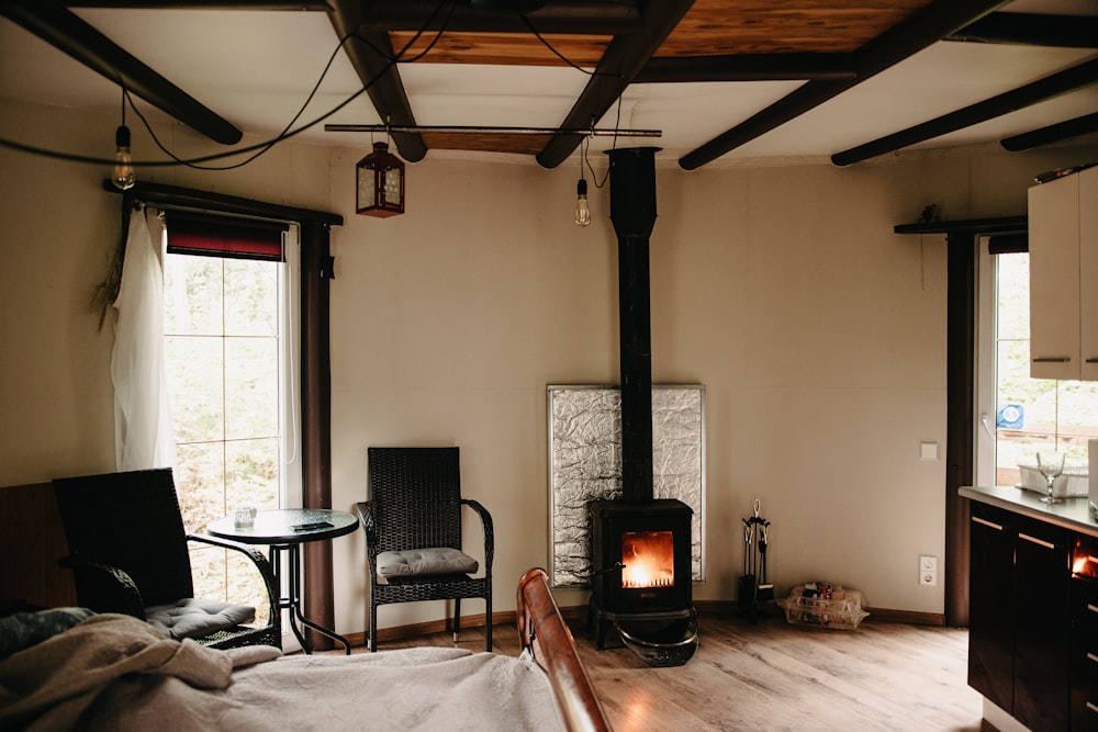 black fireplace near black armchair