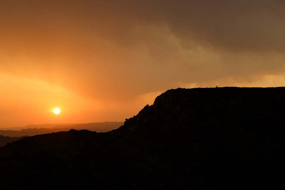 silhouette of mountain during sunset