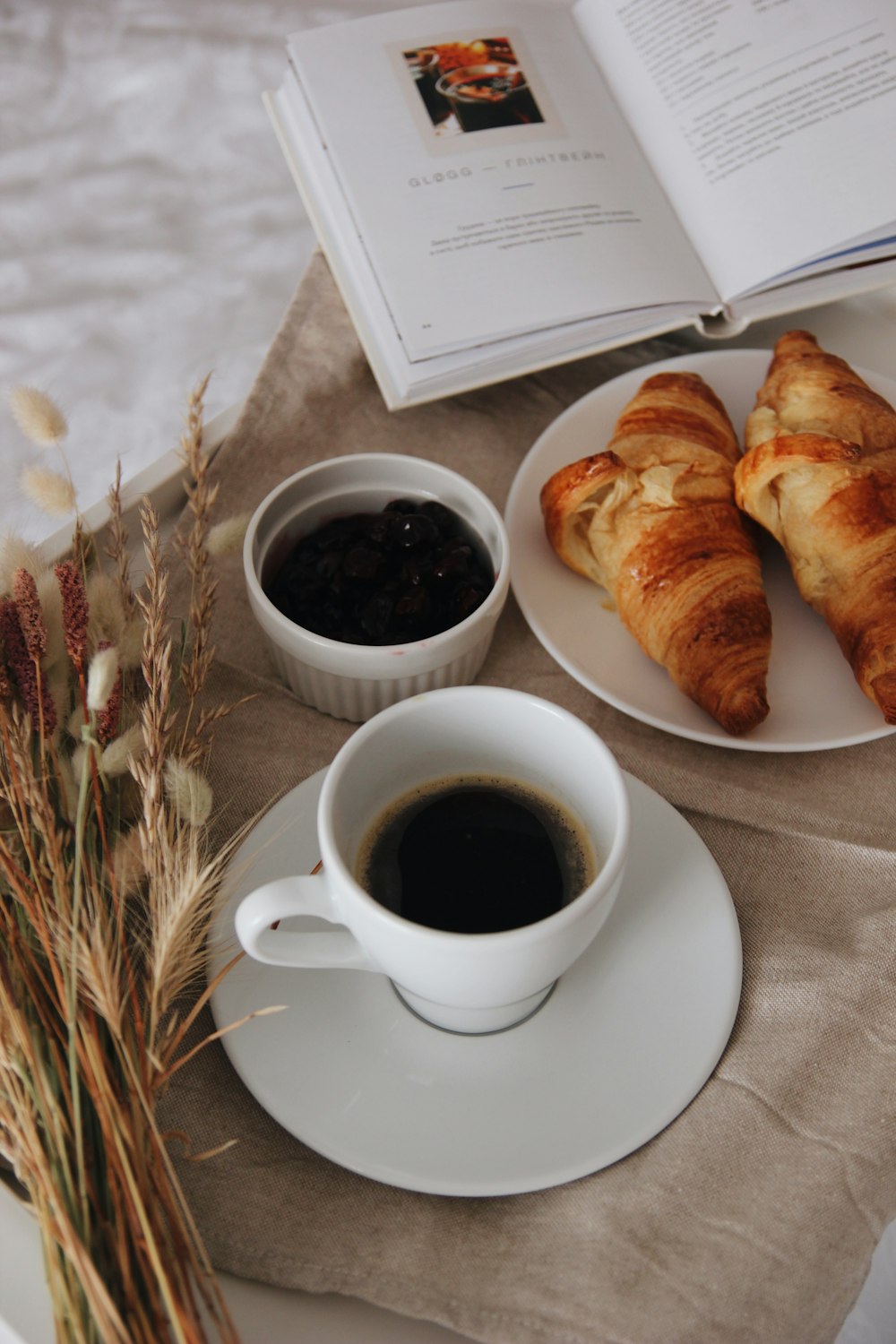 bread on white ceramic plate beside white ceramic mug