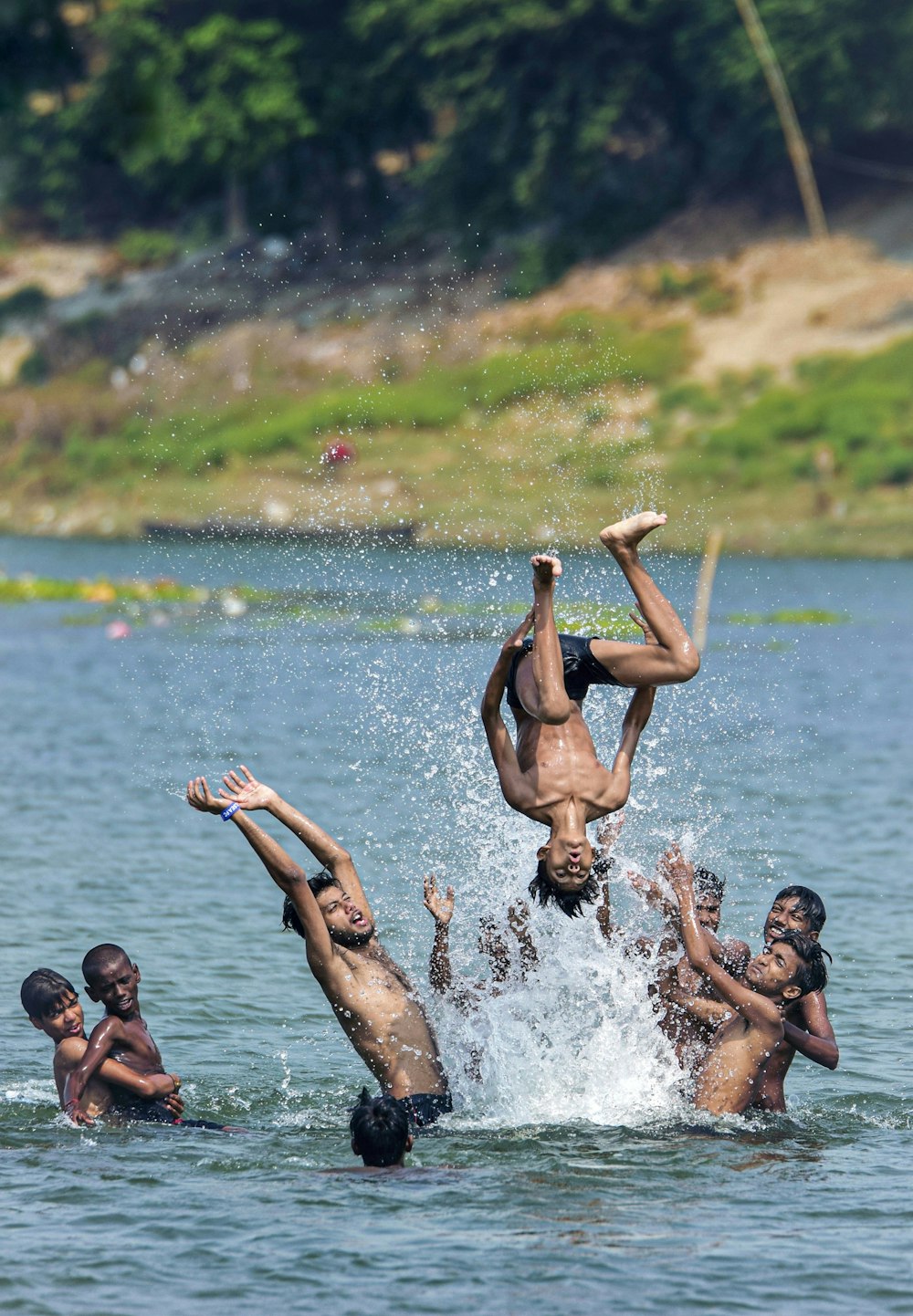 3 women in black bikini on water during daytime