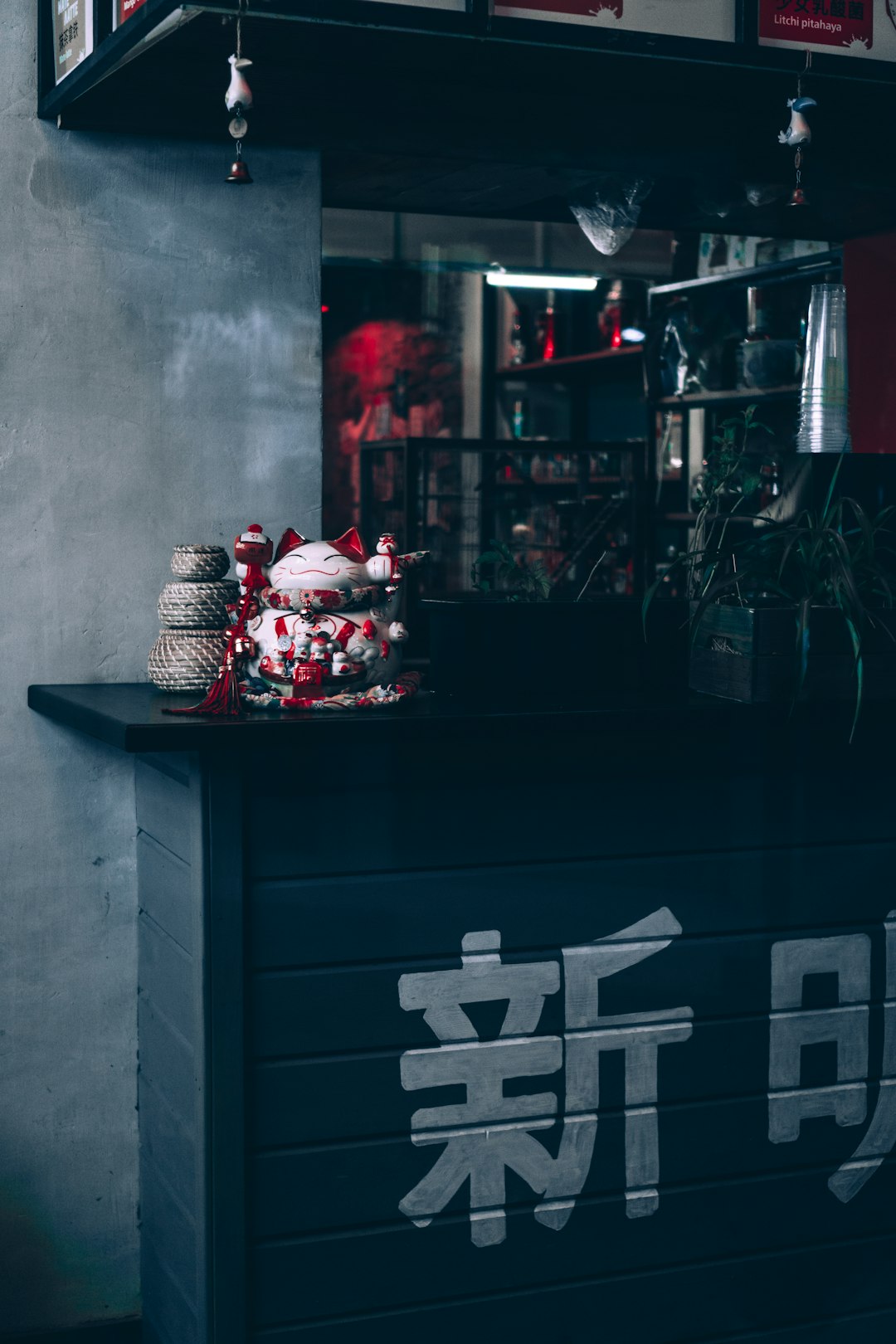 red and white gift boxes on black wooden cabinet