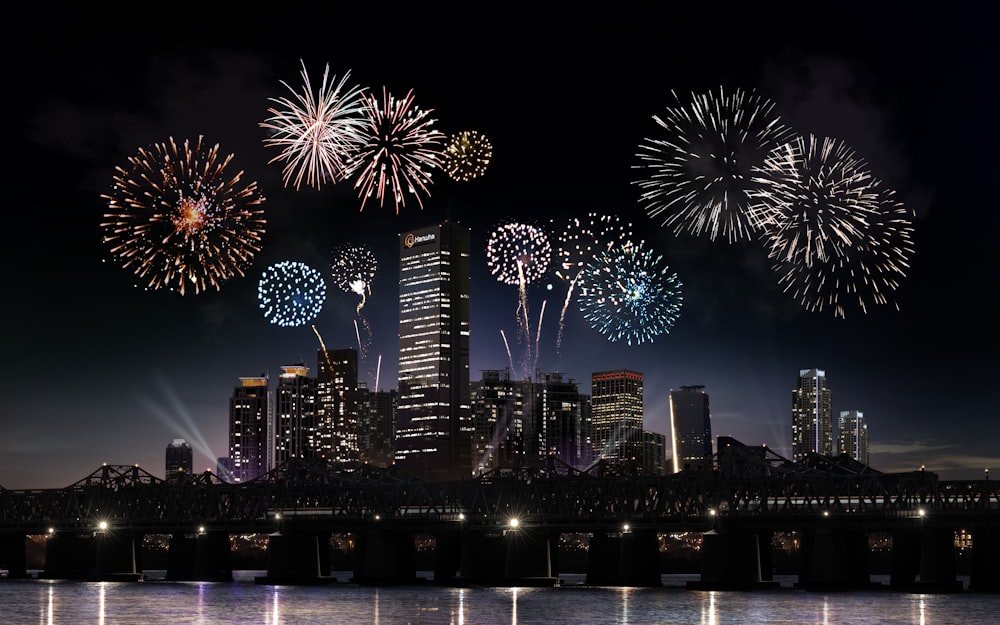 fireworks display over city buildings during night time