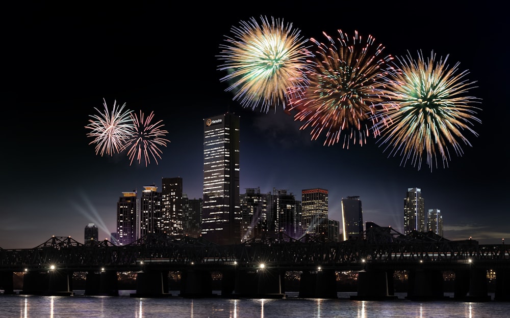 fireworks display over city buildings during night time