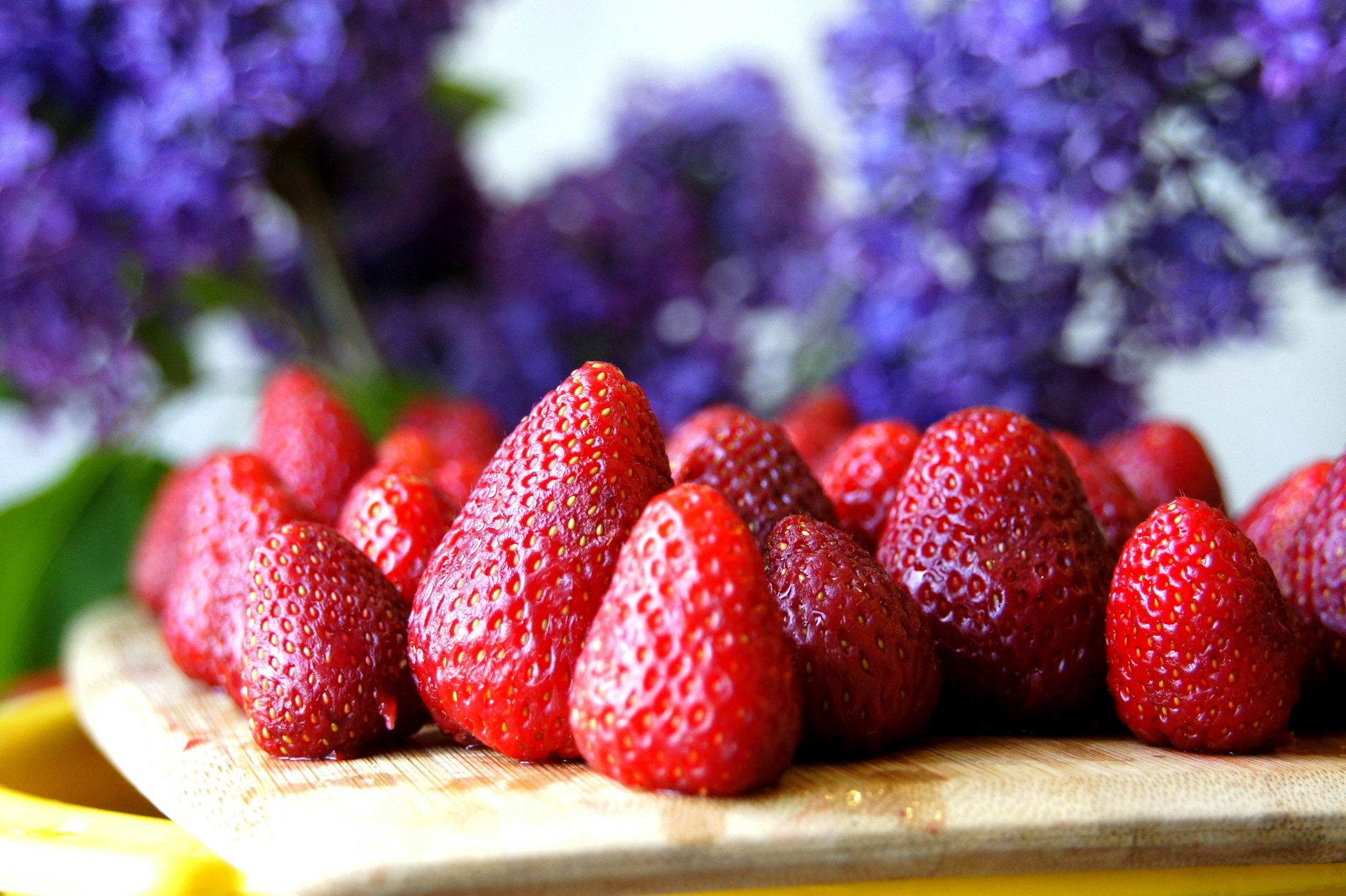 red strawberries on brown wooden table