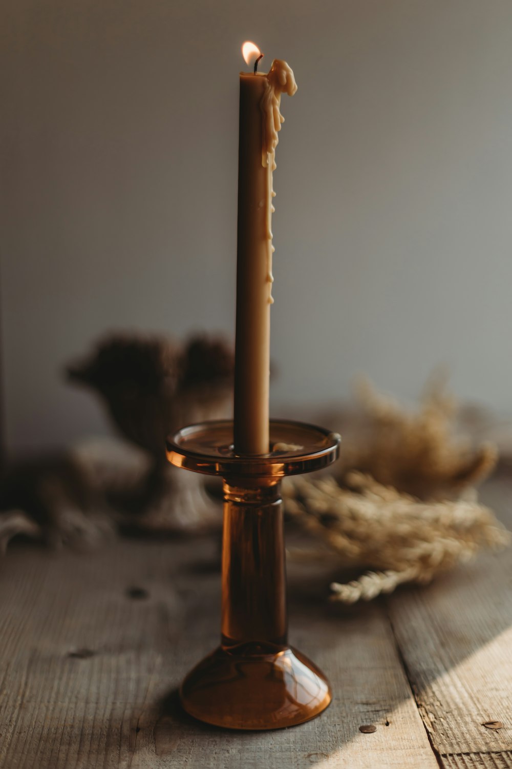 gold candle holder on brown wooden table