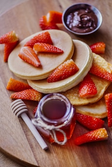 sliced strawberries on white ceramic plate