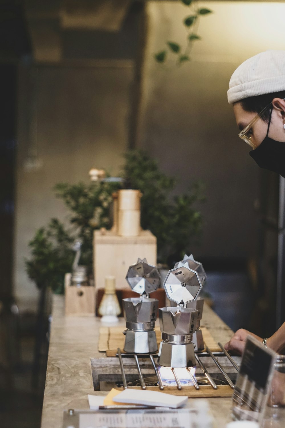 person in black shirt pouring water on silver steel cup