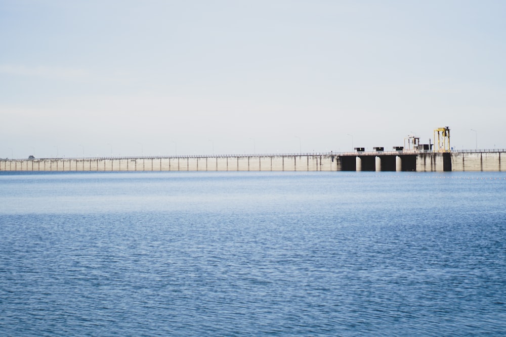 brown wooden dock on sea under white sky during daytime