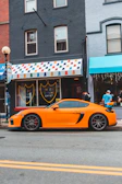 A vibrant electric cart parked on a busy urban street with sneakers displayed nearby.