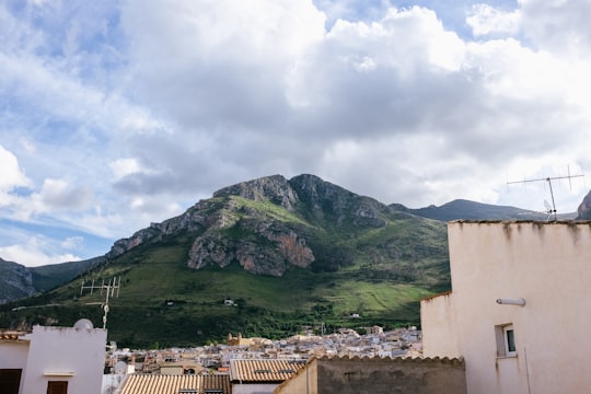 green mountain under cloudy sky during daytime in Castellammare del Golfo Italy