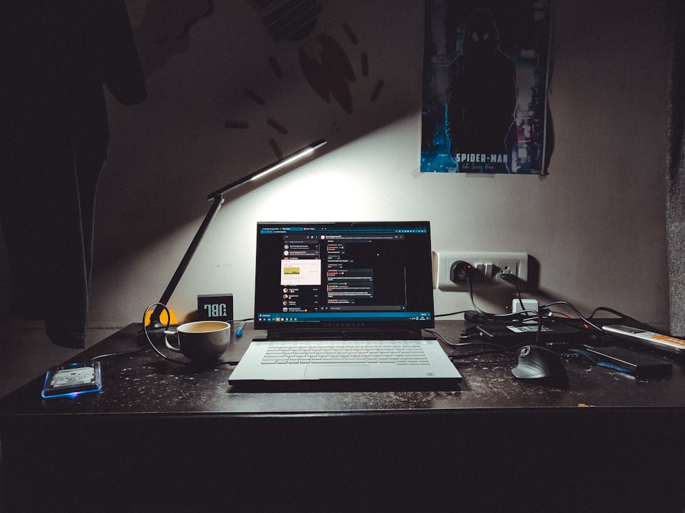 macbook pro on black table