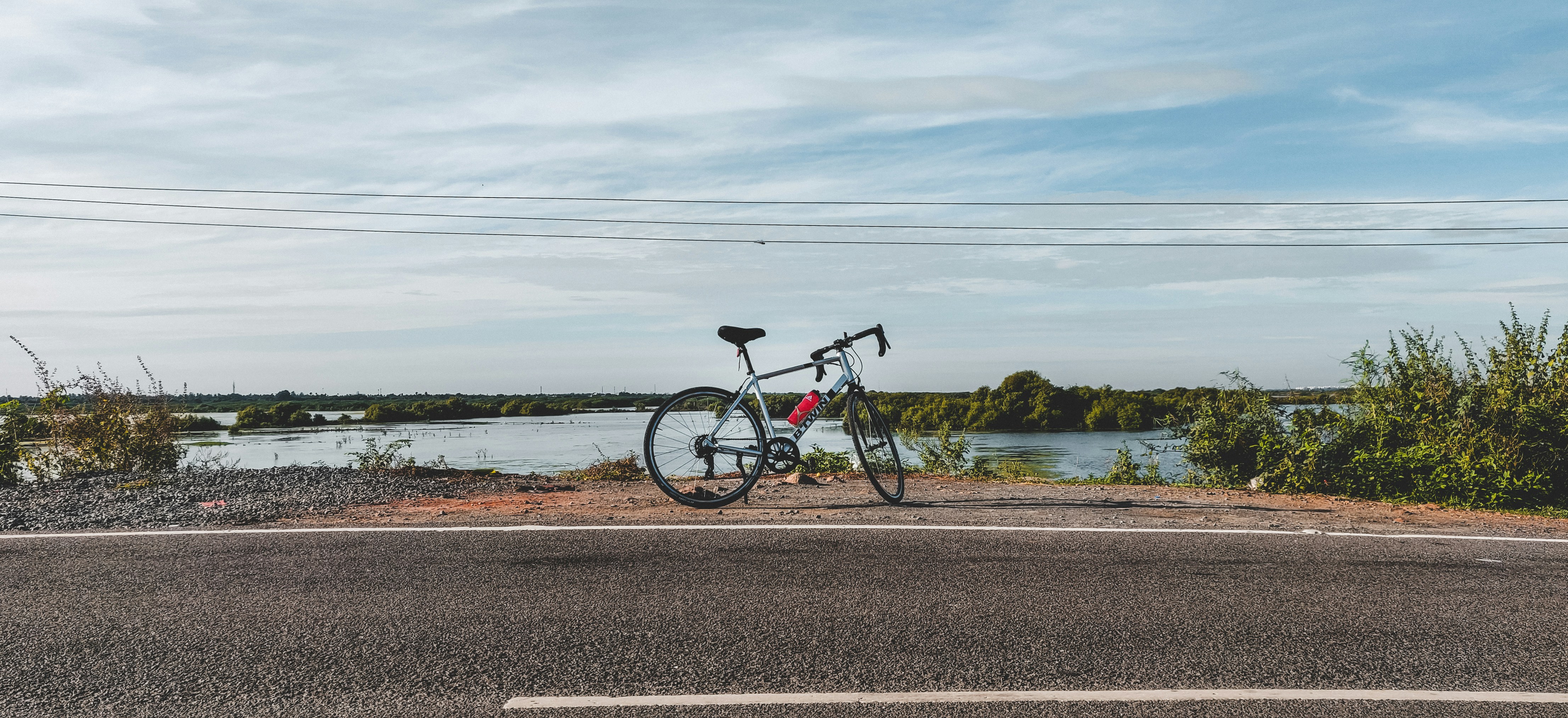 black bicycle on gray asphalt road during daytime