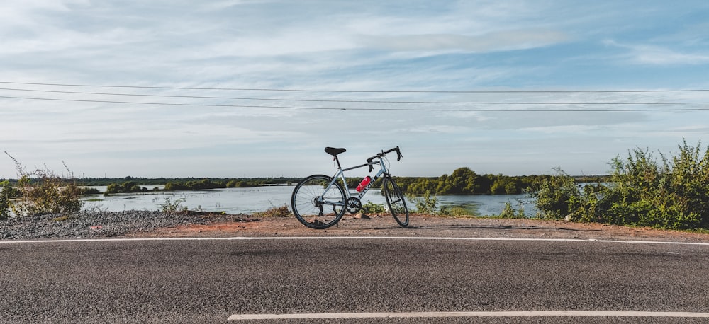 black bicycle on gray asphalt road during daytime