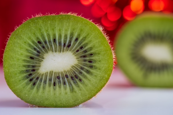 A close-up of fresh kiwi seeds glistening under natural light.
