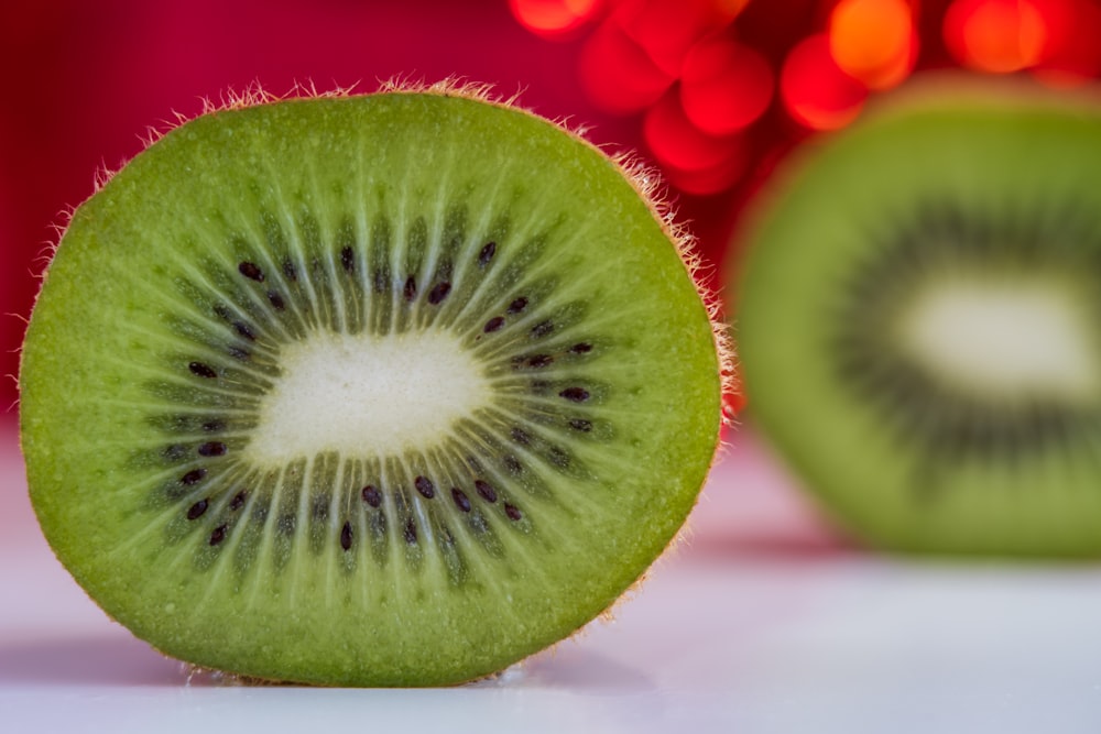 sliced green fruit on white table