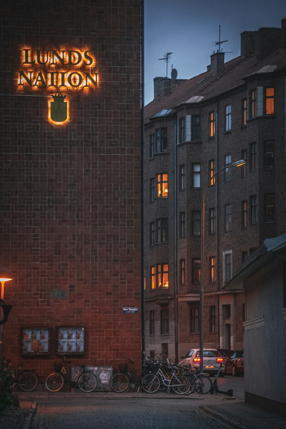 brown brick building with lights turned on during night time