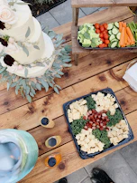 A rustic wooden table filled with an assortment of appetizers and finger foods.