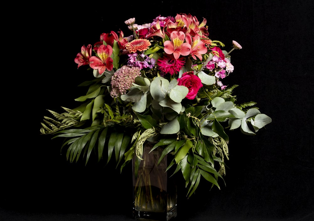 pink and white flowers in clear glass vase