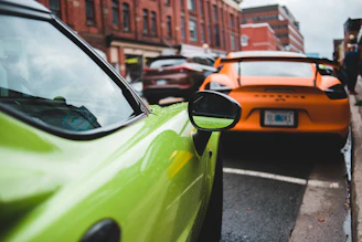 Mazda 2 parked beside a city street with vibrant urban background