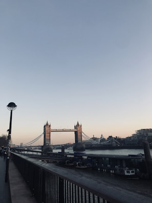 View of the iconic Paulo Afonso Bridge at sunset over the São Francisco River.