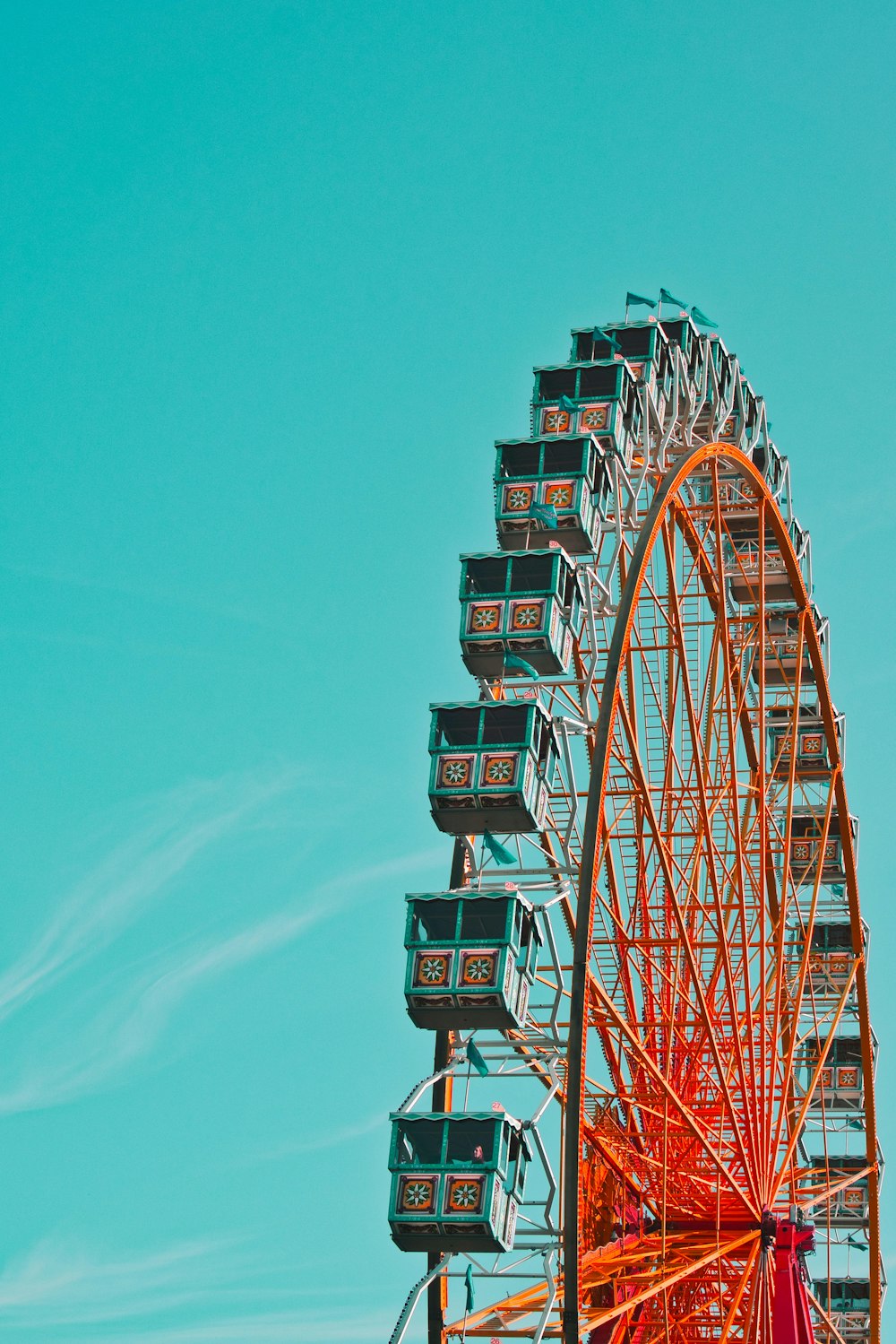 red and green ferris wheel under blue sky during daytime