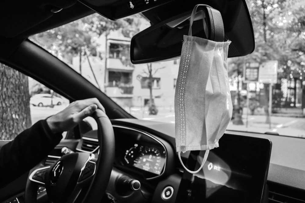 grayscale photo of car steering wheel