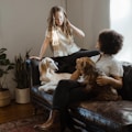 woman in white shirt sitting on black leather couch