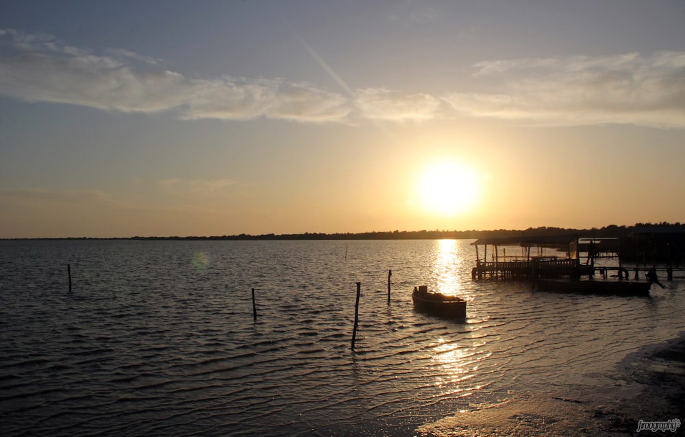 silhouette of a person on a dock during sunset